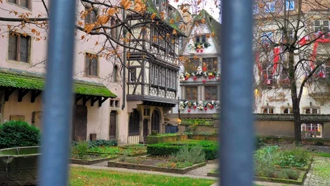 Plane backwards crossing gate next to Strasbourg courtyard at Christmas sunset Stock Footage 124479888