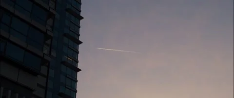 Plane behind a scyscraper in sunrise. Stock Footage 252355564