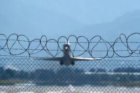 Plane Beyond the Barbed Wire. Stock-Fotos