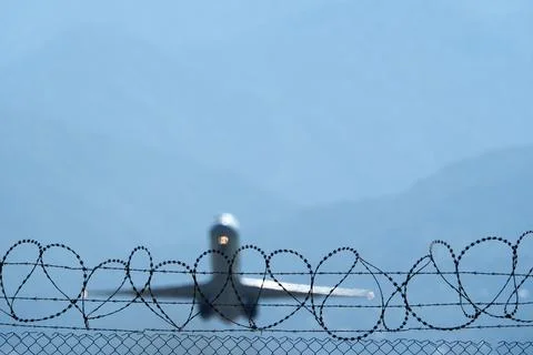 Plane Beyond the Barbed Wire. Stock Photos