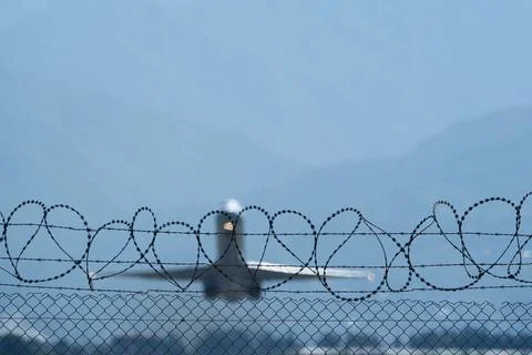 Plane Beyond the Barbed Wire. Stock Photos