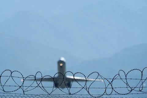 Plane Beyond the Barbed Wire. Stock Photos