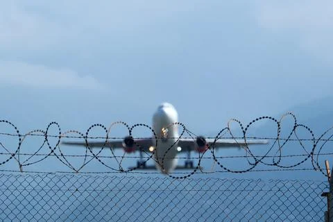Plane Beyond the Barbed Wire. Stock Photos