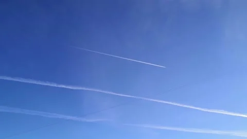 Plane on  blue sky. Conspiracy theory chemtrails behind airplane Stock Footage 150953351