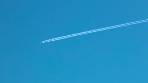 A plane in the blue sky creating a white line Stock Footage 85107327