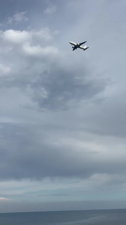 Plane in blue sky over blue sea Stock Footage 337110817