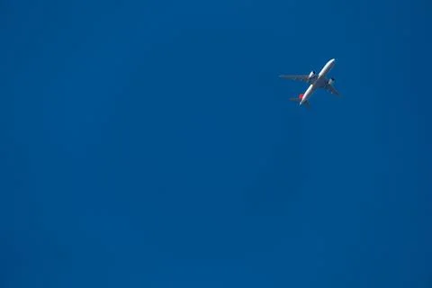 Plane in the blue sky Stock Photos