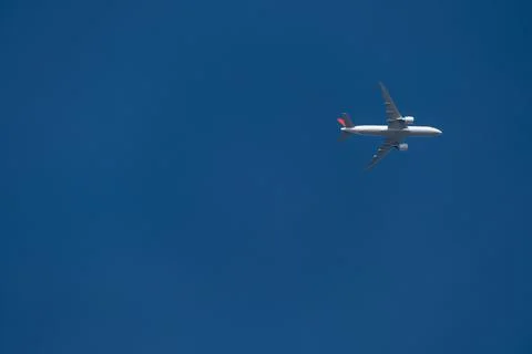 Plane in the blue sky Stock Photos