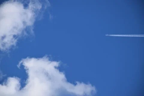 A plane in a blue sky Stock Photos