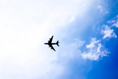 Plane in the bright sky Stock Photos