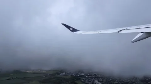 Plane climbing through the clouds, plane wing pov. Stock Footage 343881886