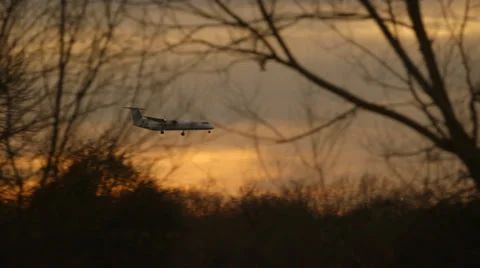 Plane coming into land at sunset - pan Video stock 36129406