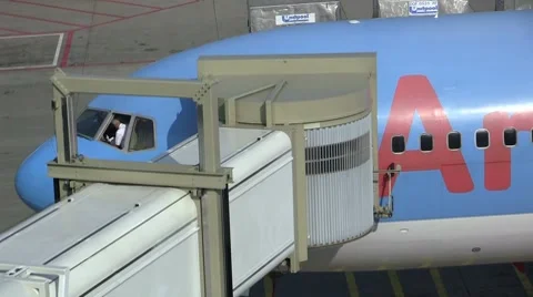 Plane connected to gate Stock Footage 8621370