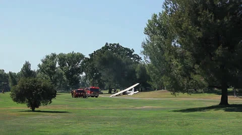 PLANE CRASHES ON GOLF COURSE WIDE Stock Footage 22952367