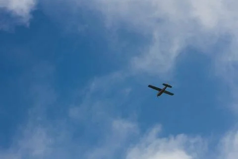 Plane crosses the blue sky Stock Photos