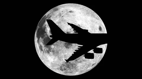 A plane crossing the face of the moon Stock Footage 40723961