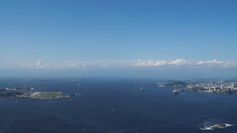 Plane crossing the sky in Rio de Janeiro Guanabara Bay Stock Footage 125056820