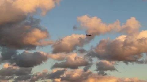 Plane crossing sunset sky Stock Footage 159579079
