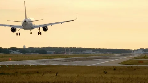 Plane descends for landing at sunset Video stock 117097174