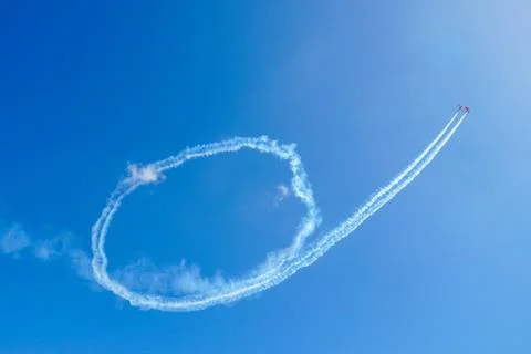 Plane doing acrobatic formation in the blue sky. Airplanes on airshow Stock Photos