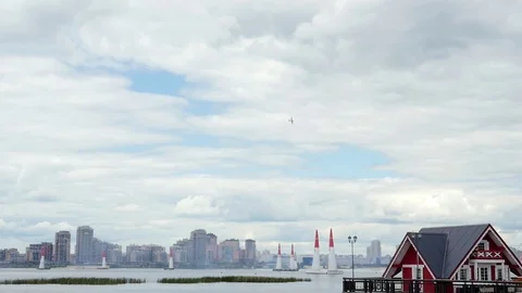 A plane is doing advanced aerobatics high above the city. Stock Footage 121597936