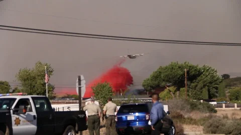 Plane drops red fire retardant Stock Footage 114413434