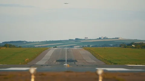 Plane far away in the sky flying to the runway to land at airport located in Stock Footage 125477445