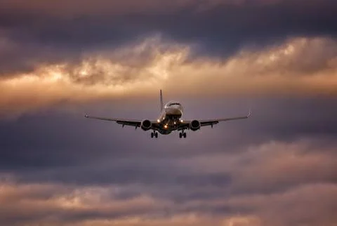 Plane on final approach with wheels down and dramatic sky, palma airport, mal Stock Photos