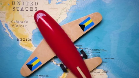 A plane with a flag of Bahamas crossing the map. Stock Footage 143980644
