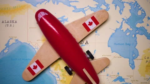 A plane with a flag of Canada crossing the map. Stock Footage