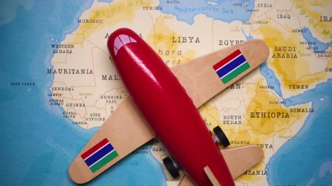 A plane with a flag of Gambia crossing the map. Stock Footage 143981653