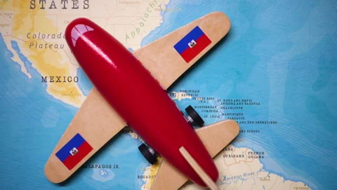 A plane with a flag of Haiti crossing the map. Stock Footage 143981806