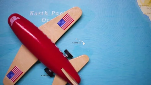 A plane with a flag of Hawaii crossing the map. Stock Footage 143983161