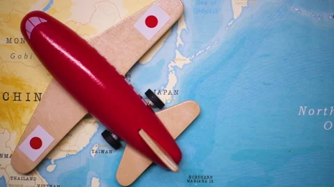 A plane with a flag of Japan crossing the map. Stock Footage 143982001