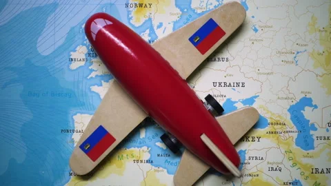 A plane with a flag of Liechtenstein crossing the map. Stock Footage 143983549