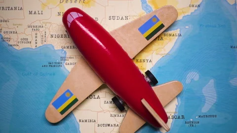 A plane with a flag of Rwanda crossing the map. Stock Footage 143982642