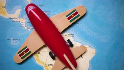 A plane with a flag of Suriname crossing the map. Stock Footage 143982820