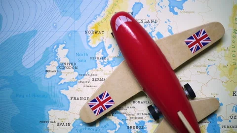 A plane with a flag of UK crossing the map. Stock Footage 143983994