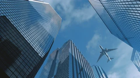 The plane flew over the top of the financial building 스톡 동영상 177210689