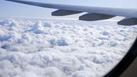 The plane flies above the clouds. View from the porthole to the sky. Vídeos de archivo 117752845
