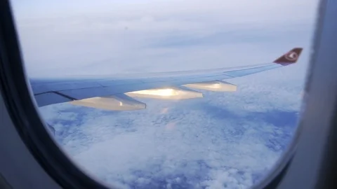 The plane flies above the clouds. View from the porthole to the sky. Stock-Footage 117753579