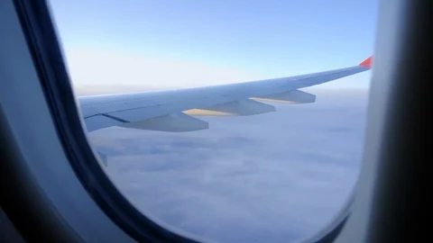 The plane flies above the clouds. View from the porthole to the sky. Video stock 117753759