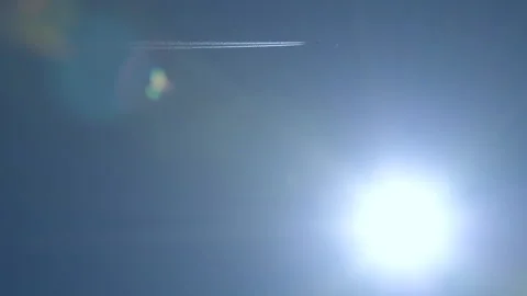 Plane flies above sun with real flare - 02 Stock Footage 132042801