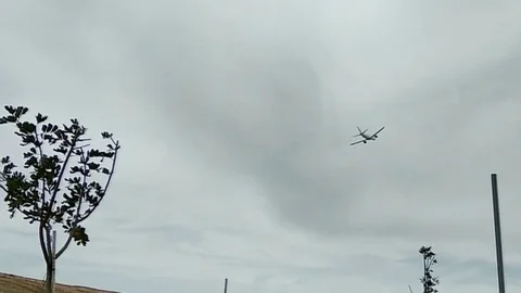 The plane flies across the sky under the clouds Stock Footage 104700517