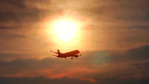 The plane flies against the background of the sunset Video stock 91700719