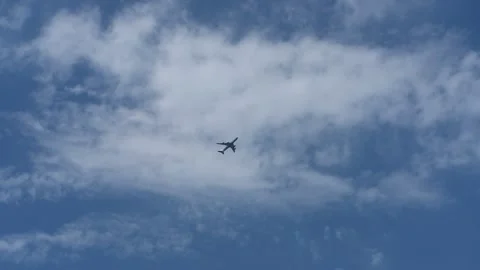 The plane flies against the background of white clouds. Stock Footage 154255799