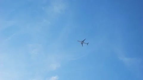 The plane flies against the blue sky. Stock Footage 233976360