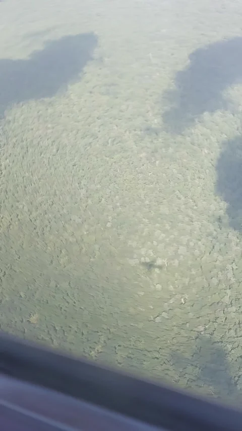 The plane flies in the clouds and through the rainbow and casts a shadow Stock Footage 317357583