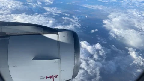 Plane flies in the clouds during the day Stock Footage 333570540