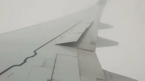 The plane flies into the clouds. Turbulence in an airplane Stock Footage 172126249